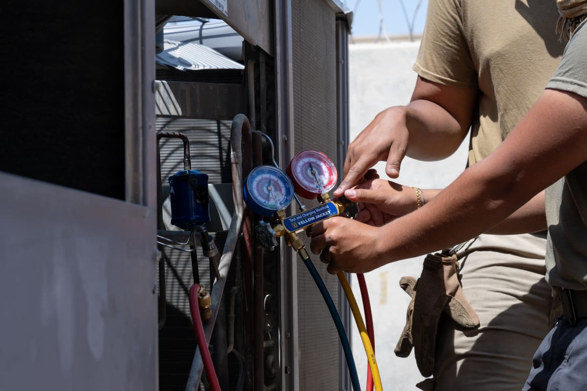 Technician checking refrigerant gauges during an emergency AC repair, Lightning Fast A/C & Heating, Hillsborough County FL